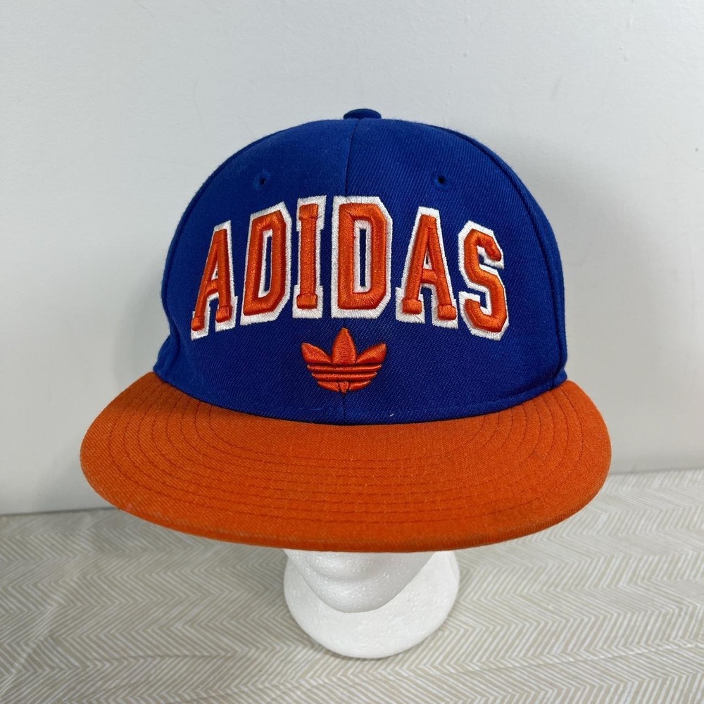 Adidas has baseball cap orange/blue raised letters and logo under them.